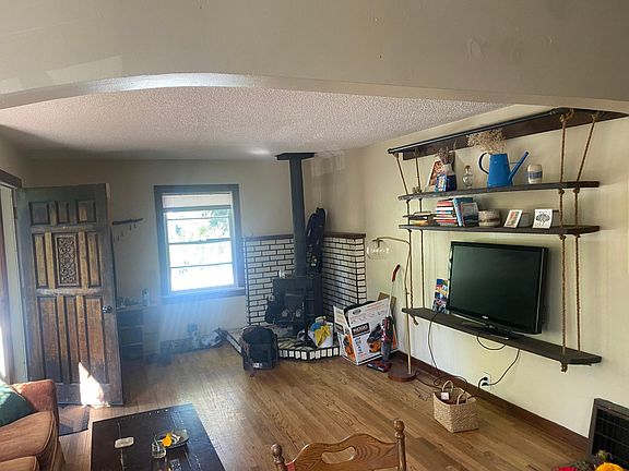 great room w hardwood floors and cozy woodstove