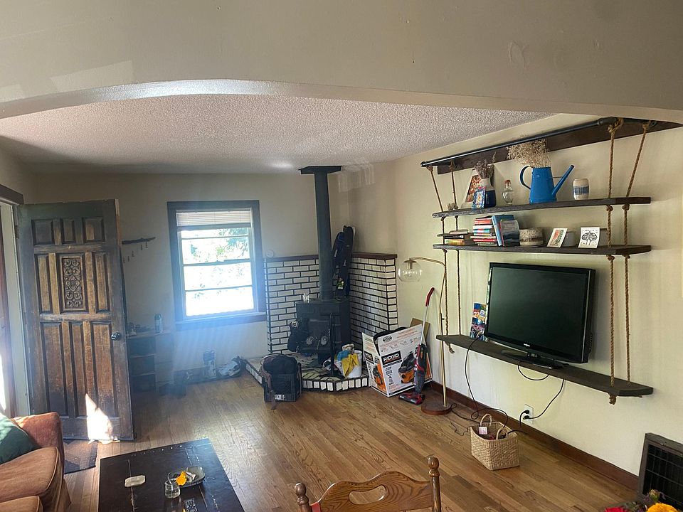 great room w hardwood floors and cozy woodstove