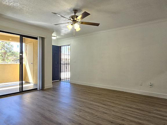 NEWLY INSTALLED CEILING FAN AND BLINDS WITH CROWN MOLDING AND NEWLY INSTALLED BASEBOARD