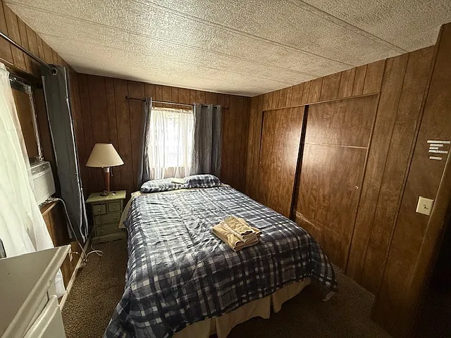 Bedroom 2 with large closet and window air conditioner.