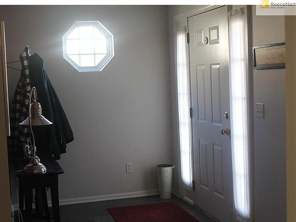 Entry with slate tile floor, close to coat closet and half bath.