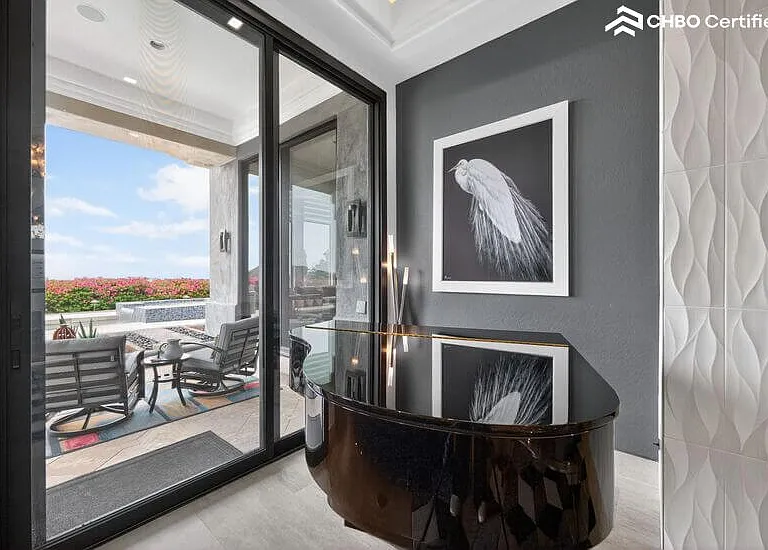 Grand piano between fireplace and pool lanai