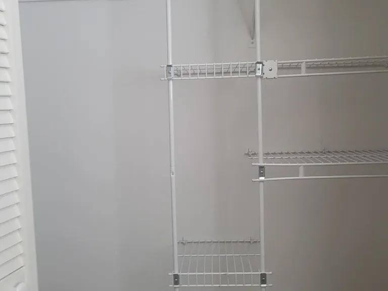 Inside of closet in 2nd bedroom with Queen bed. A large closet with shelving.