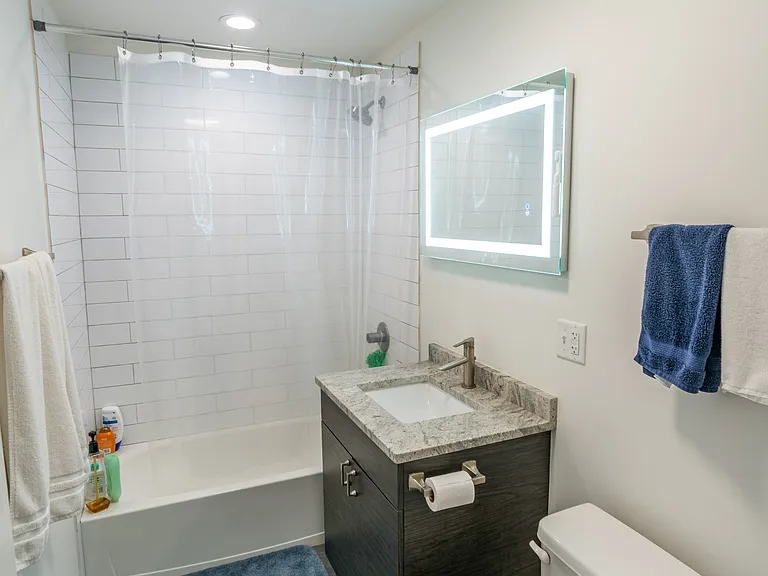 Bathroom with tub and lighted mirror!