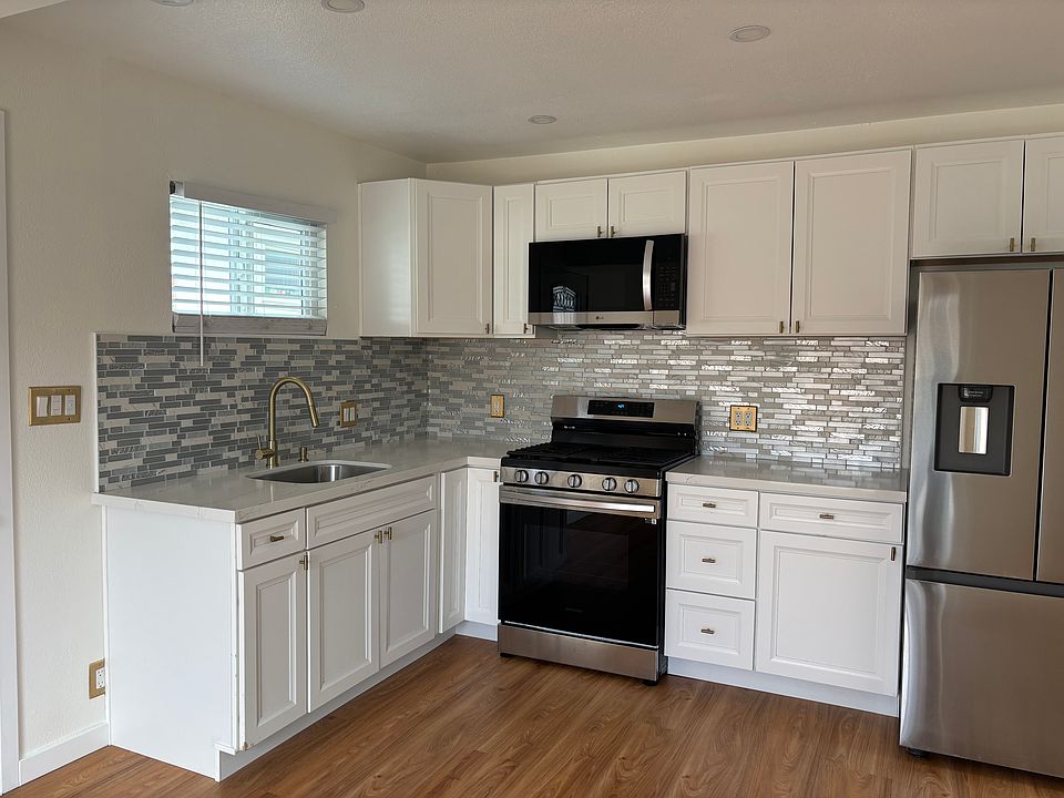 Brand new quartz countertops and stainless steel appliances with new shaker soft close cabinets