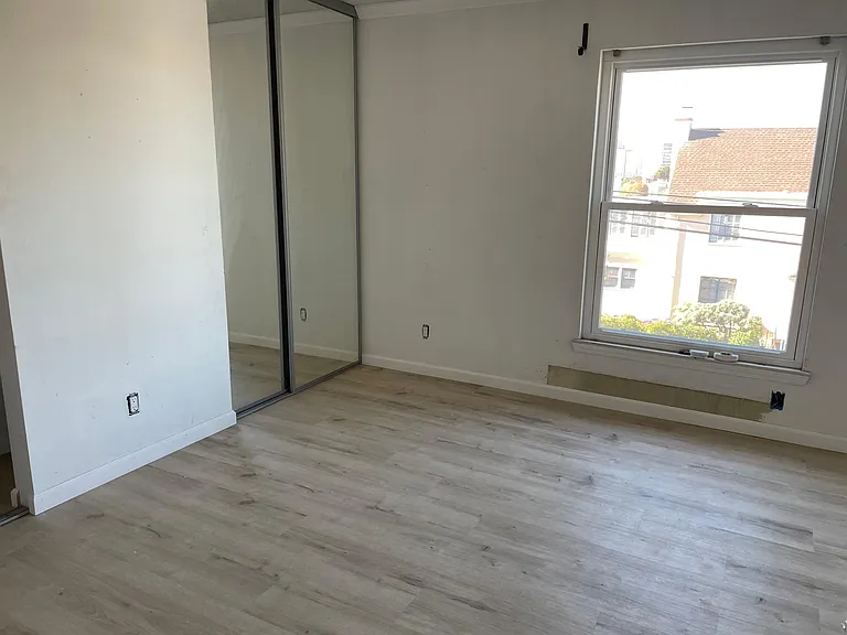 BEDROOM with WALL TO WALL CLOSET WITH MIRROR CLOSET DOORS with BEAUTIFUL SUNSETS