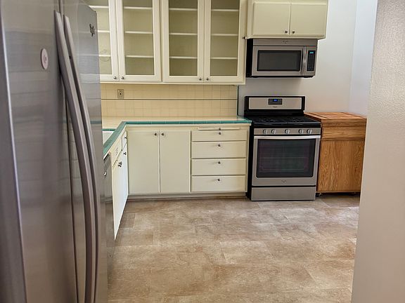 kitchen with natural gas range, microwave oven, refrigerator, dishwasher, garbage disposal, etc.