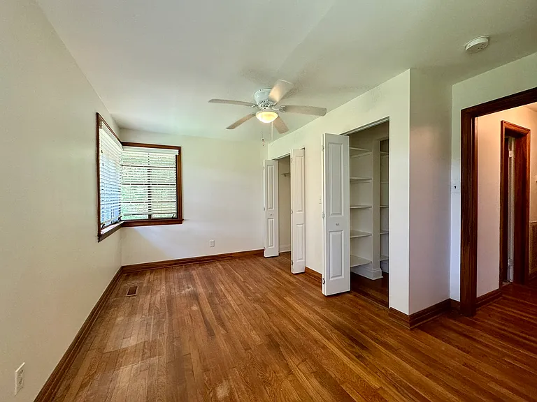 Bedroom 1 with hardwood flooring; spacious closets.