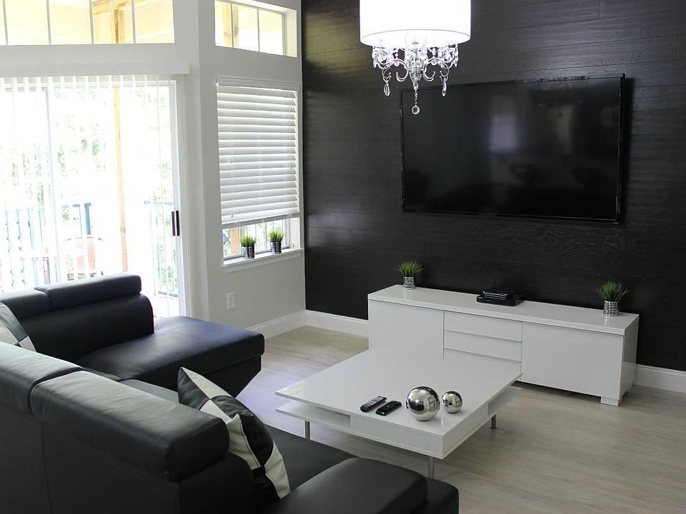 living room with a sectional sofa and 60" smart tv.
