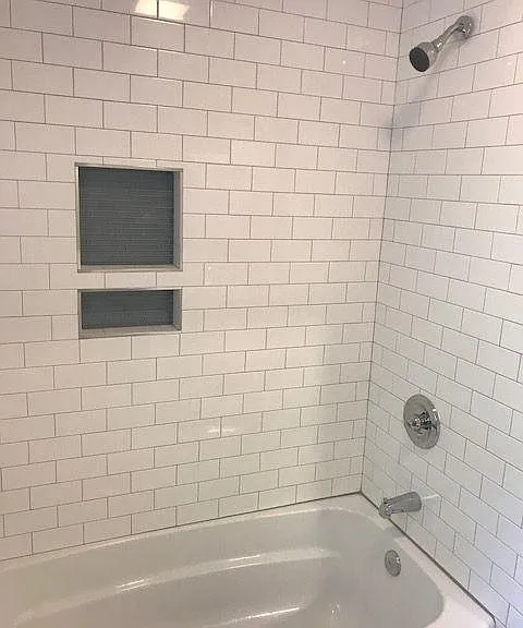 hall bath and shower with tile surround