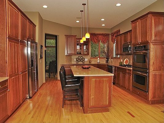 Cherry cabinets and quartz countertops round out this stunning kitchen