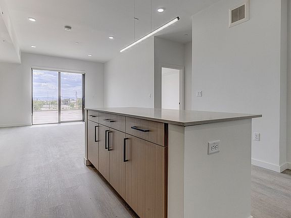 Open-concept living with a spacious kitchen island and contemporary finishes.