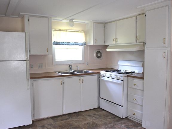 The kitchen features new vinyl flooring and updated appliances.