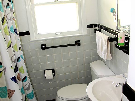 Main floor bathroom w/ large closet and medicine cabinet