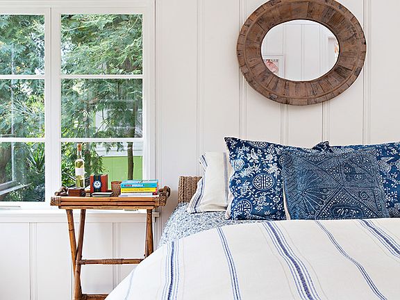 Master bedroom with doors leading to outdoor lounge area.