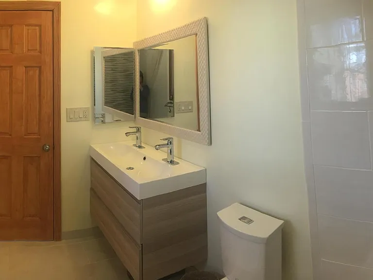 Bathroom of Main BR with double-sink and window.
