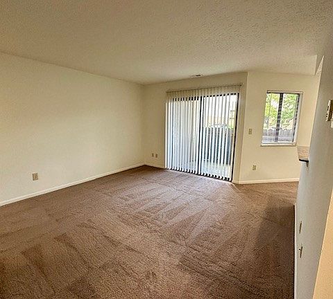 Another view of living room and slider doors to patio