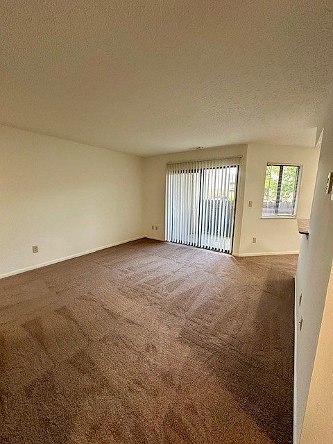 Another view of living room and slider doors to patio