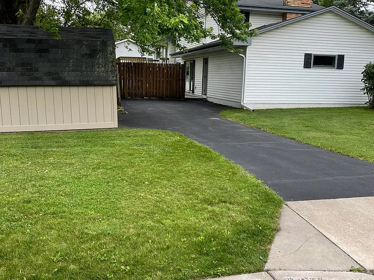 Second driveway parking in rear, with garage access and storage shed.