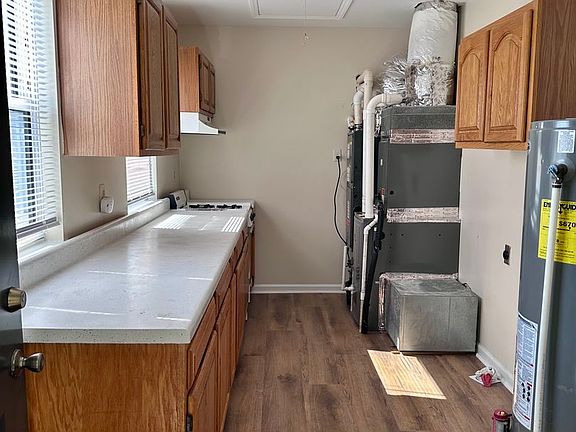 Back entrance into Laundry Room. This room has HVAC, water heater, washer and dryer hookups, and a lot extra cabinet storage.