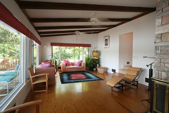 Living Room w/ Hardwood and an abundance of windows
