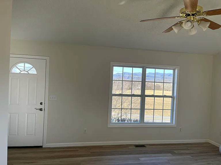 Living room with visible mountain views through front window