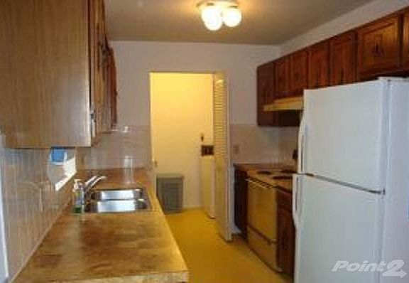 Kitchen featuring Wood Cabinets