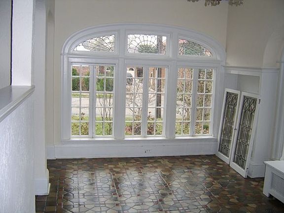 Captivating Sunroom with Built-ins, Terrazzo, and Lots of Leaded Glass