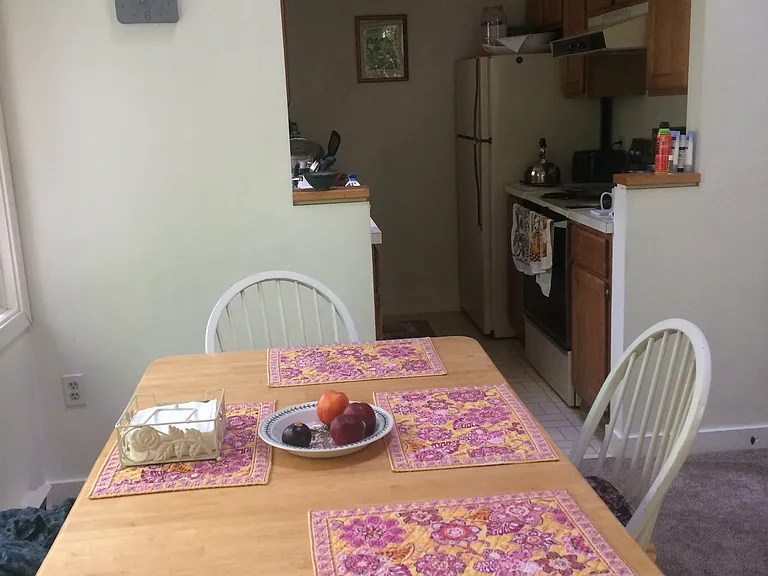 dining room table with kitchen beyond