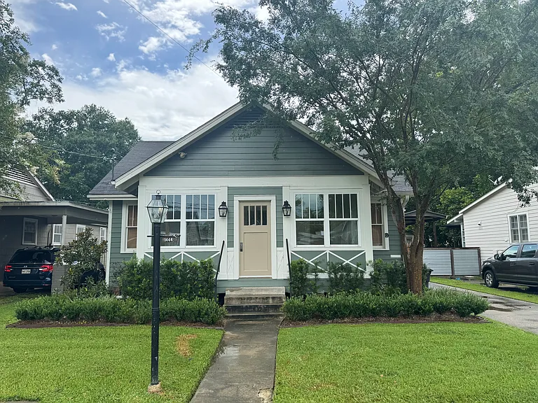 Front of home with new AC controlled sunroom.