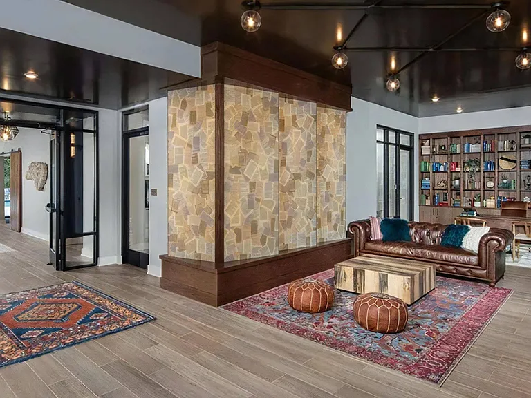 Modern Resident Lounge with Cozy Seating and Built-In Bookcase Wall