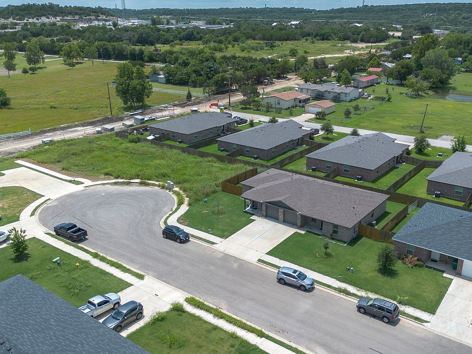 Stunning aerial view showcasing a serene neighborhood and a well-maintained duplex perfectly positioned at the end of a peaceful cul-de-sac.