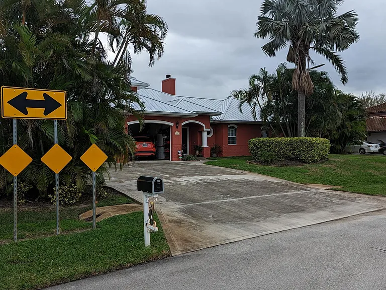 Street view, front of home and large driveway.