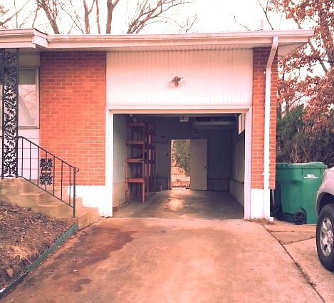 View Of Garage with exit door to fenced yard and huge Patio