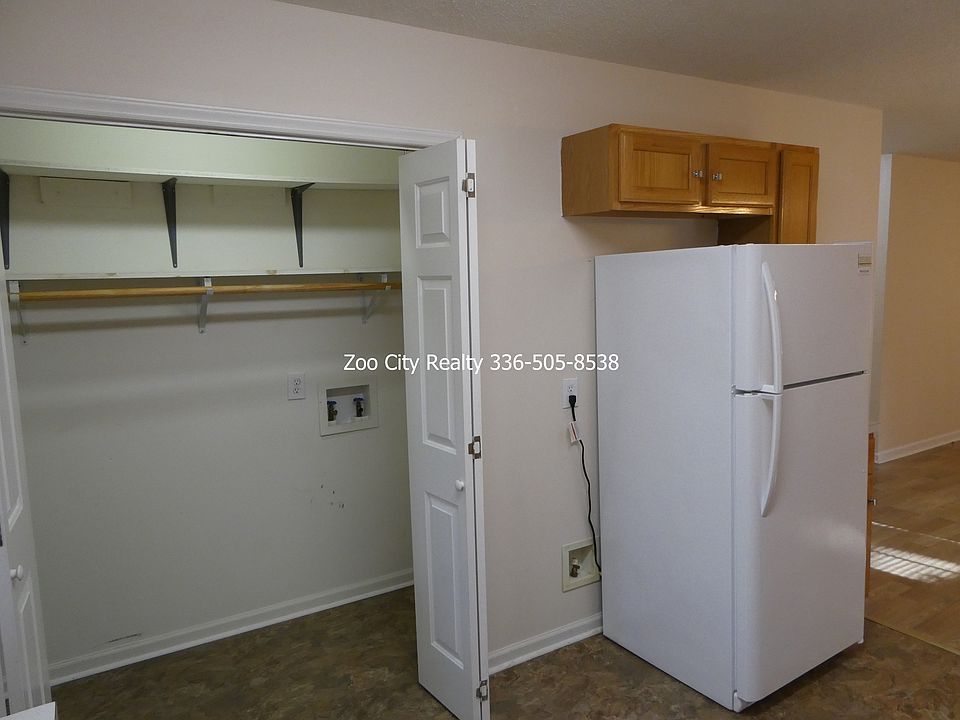 Kitchen area with washer and dryer hookups.
