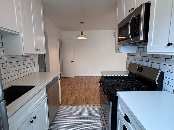 Includes dishwasher, microwave, fridge, oven, and subway tile backsplash.