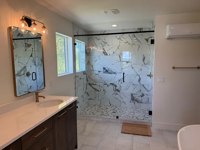 Large master bathroom with walk-in shower, double vanity, and beautiful soaking tub