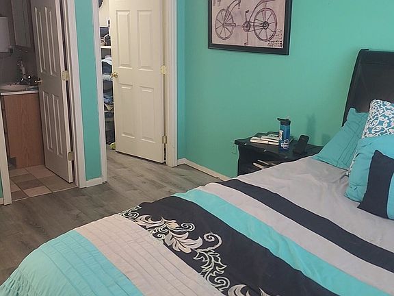 The master bedroom is attached to the large bathroom with two entry doors.