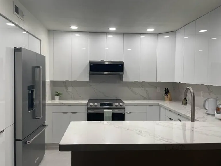 Fully equipped kitchen. All stainless steel appliances, refrigerator, low profile microwave, electric oven, and dishwasher. Glossy European style cabinets.