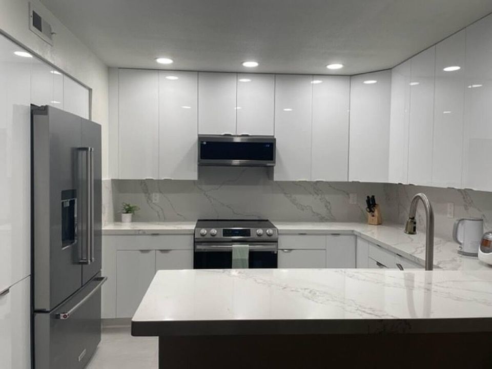 Fully equipped kitchen. All stainless steel appliances, refrigerator, low profile microwave, electric oven, and dishwasher. Glossy European style cabinets.