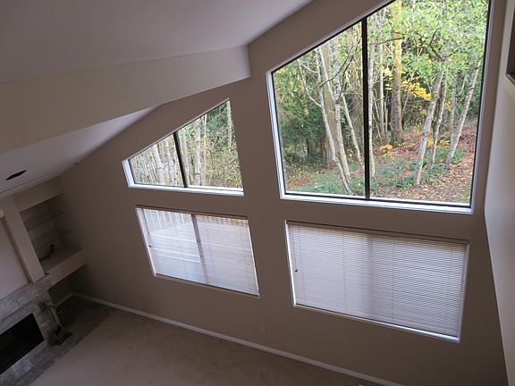 Living room large picture windows with view of trees