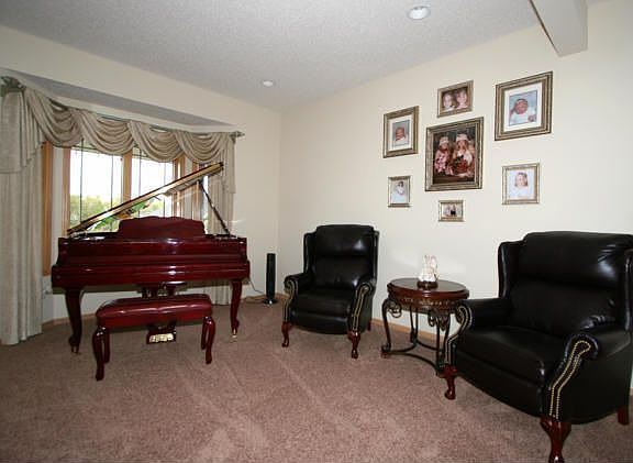 The main level also includes a formal living room and a fifth bedroom/office.