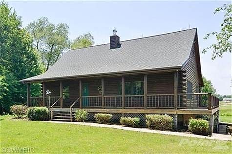 Log Home with great floor plan. Wrap around deck with larger deck on the back side.