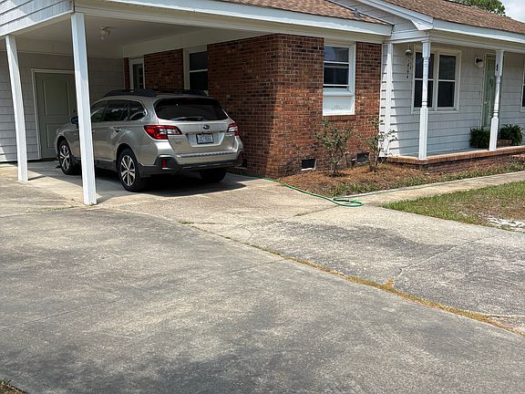 Car port with laundry and storage room