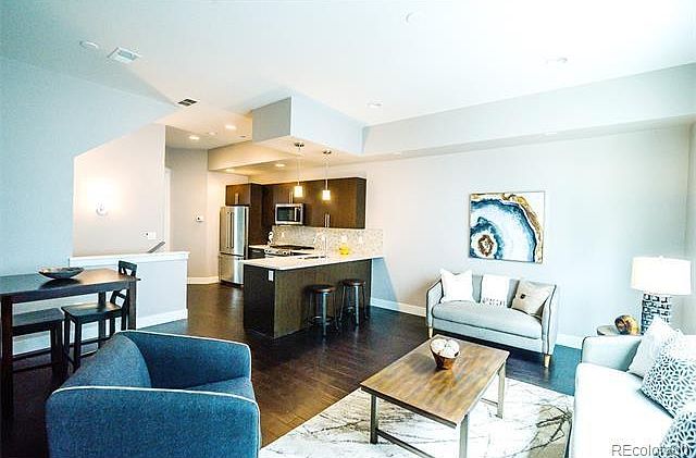 View across large living room to kitchen