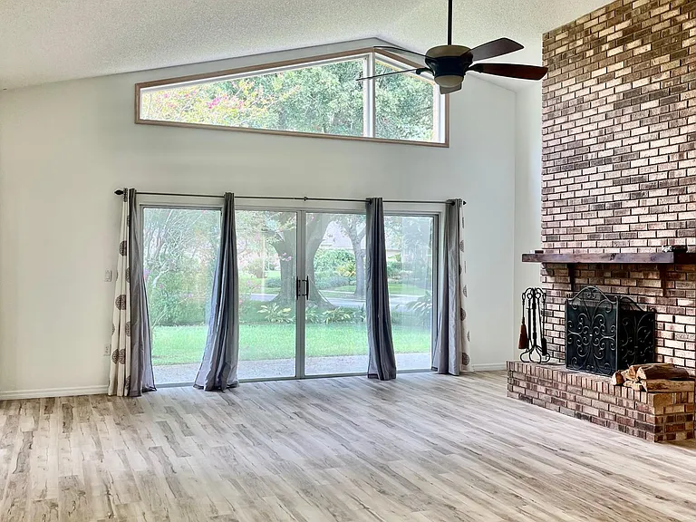 Natural lights coming from tinted glass doors. Enjoy the real wood burning fireplace in the living room area