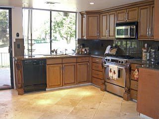 Remodeled Kitchen with garanite slab countertops and Cherry Cabinets