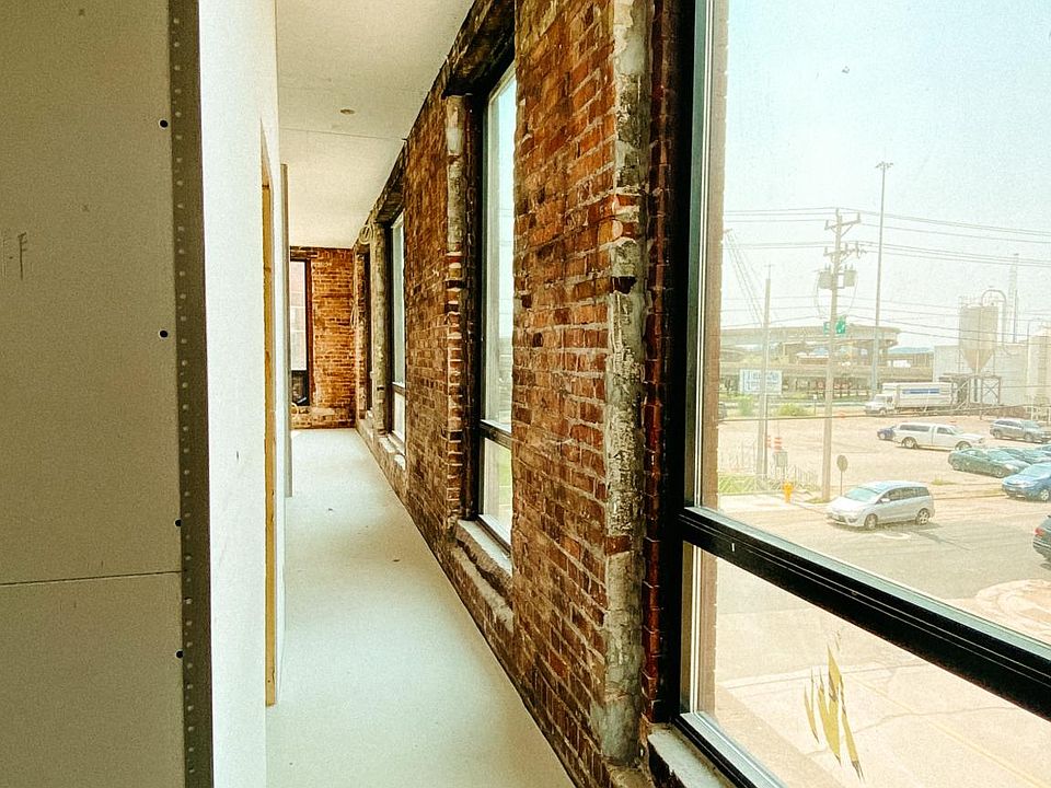 One of our two bedroom studios with a gorgeous hallway of large windows.