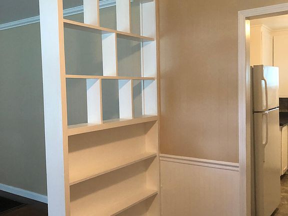 Backside of vintage wall accent piece has book shelves.