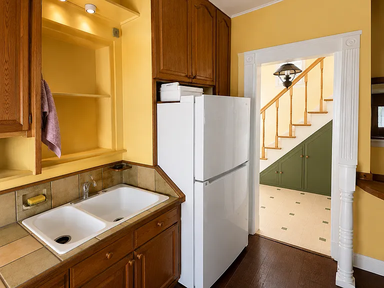 Kitchen with refrigerator and additional built-in storage _ renovation rendering